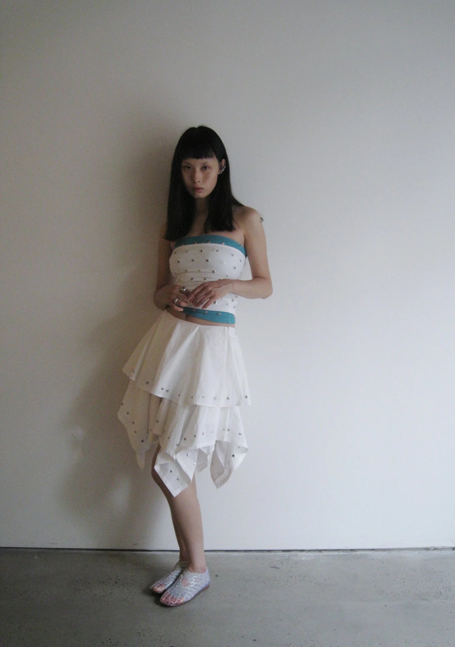 Woman wearing a strapless dress with a white background