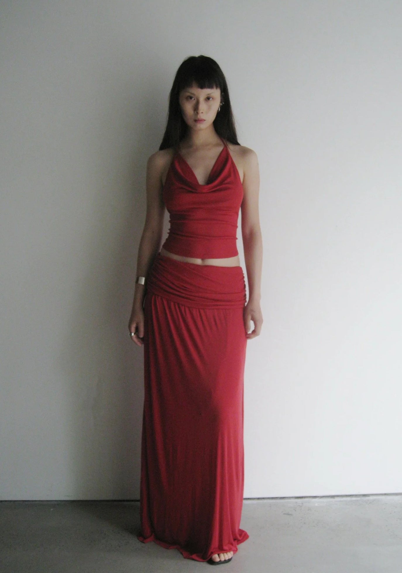 Woman wearing a red dress against a plain white background